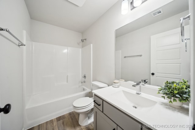12503 N 130th Ave E, Collinsville, OK 74021 - full bathroom featuring vanity, wood finished floors, toilet, and tub / shower combination