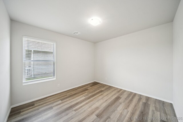 12503 N 130th Ave E, Collinsville, OK 74021 - empty room featuring wood finished floors and baseboards