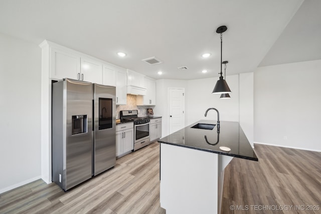 12503 N 130th Ave E, Collinsville, OK 74021 - kitchen with stainless steel appliances, a sink, light wood-style floors, baseboards, and white cabinets