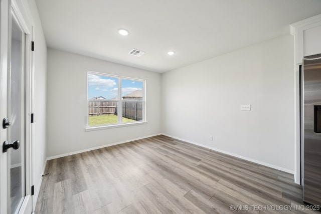 12503 N 130th Ave E, Collinsville, OK 74021 - spare room featuring wood finished floors, recessed lighting, and baseboards