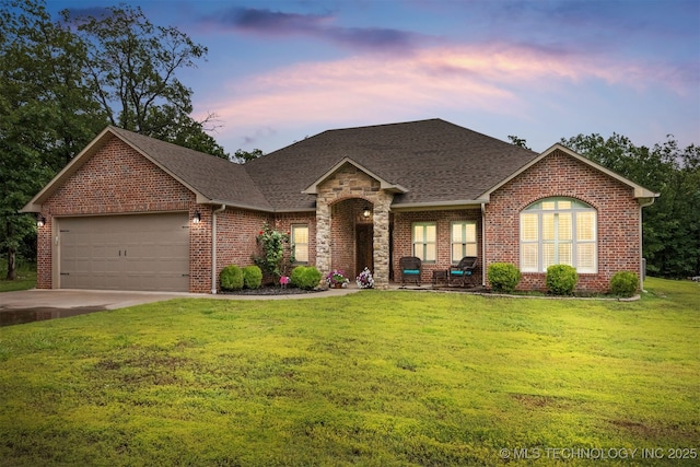 23532 N 5 Mile Rd, Fort Gibson, OK 74434 - view of front facade with roof with shingles, an attached garage, a lawn, and brick siding
