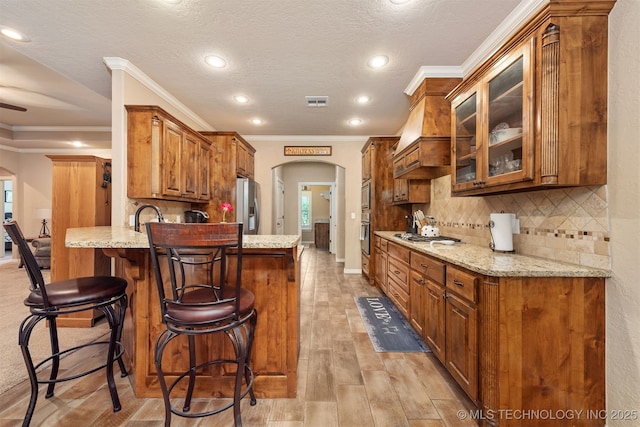 23532 N 5 Mile Rd, Fort Gibson, OK 74434 - kitchen featuring arched walkways, a peninsula, stainless steel refrigerator with ice dispenser, a kitchen breakfast bar, and crown molding