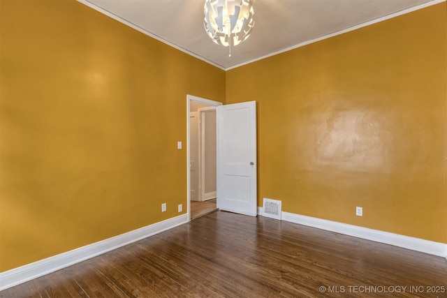 2305 E 13th St, Tulsa, OK 74104 - unfurnished room with a chandelier, ornamental molding, dark wood-style flooring, and baseboards