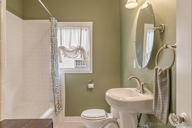 2305 E 13th St, Tulsa, OK 74104 - full bath with toilet, shower / tub combo, tile patterned floors, and baseboards