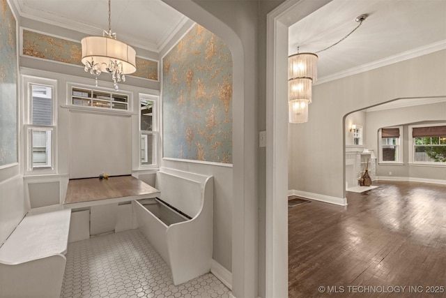 2305 E 13th St, Tulsa, OK 74104 - interior space featuring a chandelier, arched walkways, crown molding, and baseboards
