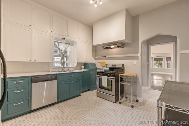 2305 E 13th St, Tulsa, OK 74104 - kitchen featuring stainless steel appliances, white cabinets, and a sink