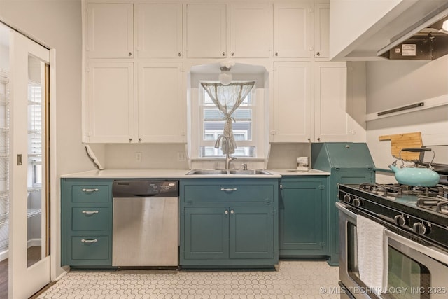 2305 E 13th St, Tulsa, OK 74104 - kitchen featuring appliances with stainless steel finishes, wall chimney exhaust hood, a sink, and green cabinetry