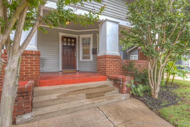 2305 E 13th St, Tulsa, OK 74104 - view of exterior entry with covered porch and brick siding