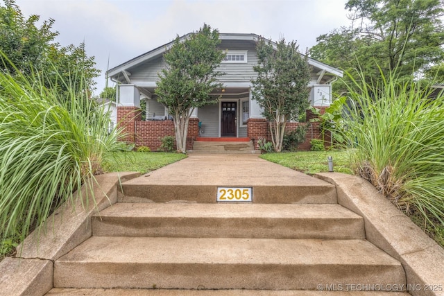 2305 E 13th St, Tulsa, OK 74104 - view of front of home featuring brick siding and covered porch