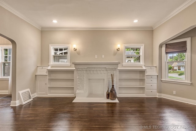2305 E 13th St, Tulsa, OK 74104 - unfurnished living room featuring arched walkways, dark wood-style floors, healthy amount of natural light, ornamental molding, and baseboards
