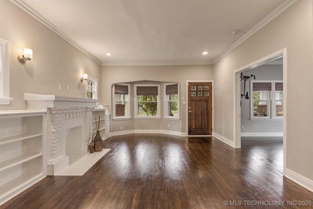 2305 E 13th St, Tulsa, OK 74104 - unfurnished living room with wood finished floors, baseboards, arched walkways, crown molding, and recessed lighting