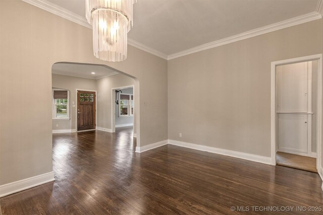 2305 E 13th St, Tulsa, OK 74104 - spare room with arched walkways, ornamental molding, dark wood finished floors, and baseboards
