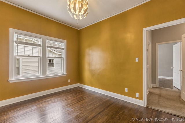 2305 E 13th St, Tulsa, OK 74104 - empty room featuring baseboards, dark wood-type flooring, ornamental molding, and a chandelier