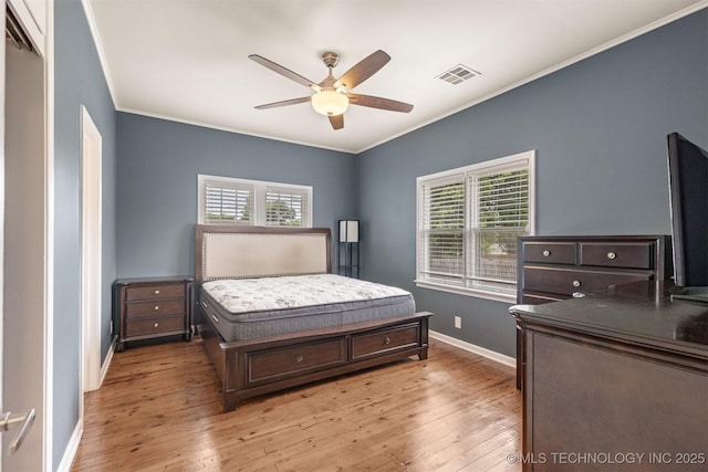 2305 E 13th St, Tulsa, OK 74104 - bedroom featuring crown molding, light wood-style flooring, multiple windows, baseboards, and a ceiling fan