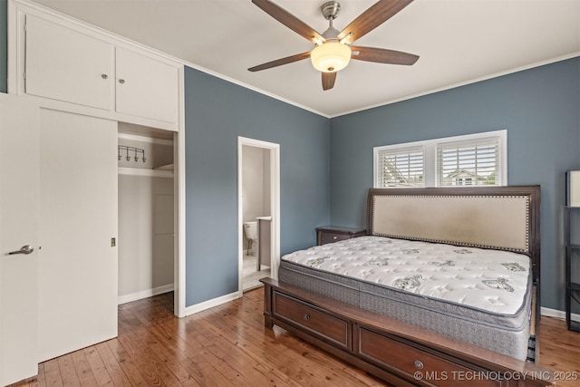 2305 E 13th St, Tulsa, OK 74104 - bedroom featuring ornamental molding, hardwood / wood-style floors, baseboards, ensuite bath, and a ceiling fan
