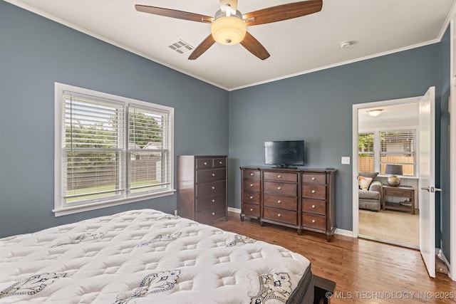 2305 E 13th St, Tulsa, OK 74104 - bedroom featuring ornamental molding, wood finished floors, baseboards, and a ceiling fan