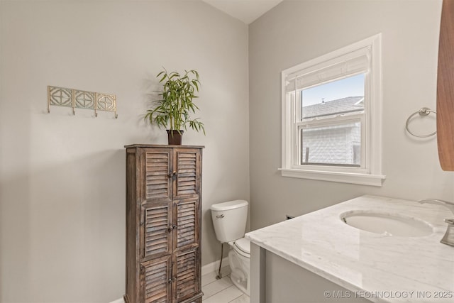 2305 E 13th St, Tulsa, OK 74104 - bathroom with toilet, vanity, tile patterned flooring, and baseboards