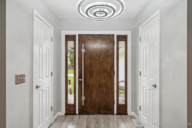 6407 S 110th E Ave, Tulsa, OK 74133 - entryway featuring a chandelier, light wood-style flooring, and baseboards