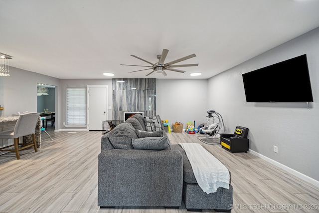 6407 S 110th E Ave, Tulsa, OK 74133 - living area featuring baseboards, light wood finished floors, and a ceiling fan