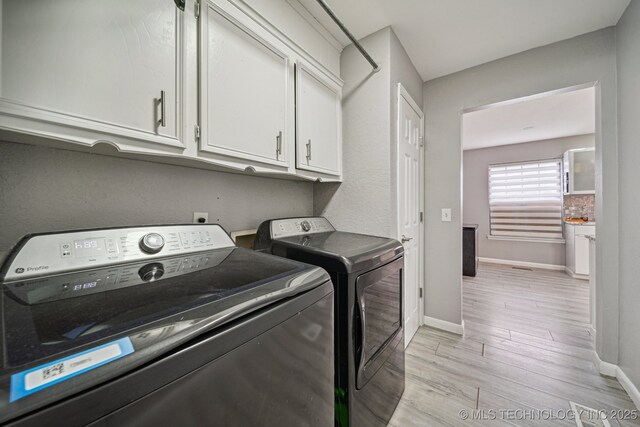 6407 S 110th E Ave, Tulsa, OK 74133 - laundry room featuring cabinet space, washer and dryer, light wood finished floors, and baseboards