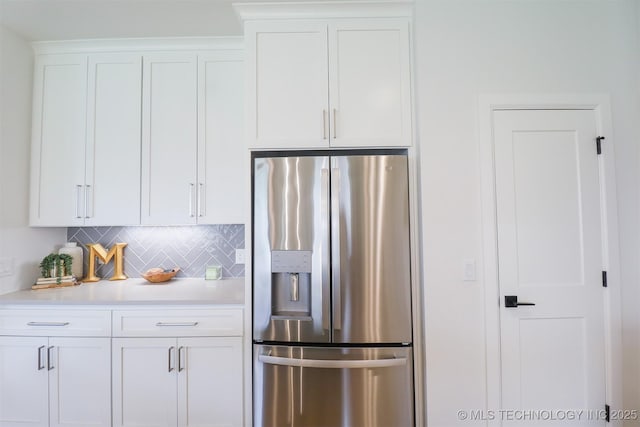 13657 S 21st Ct E, Bixby, OK 74008 - kitchen with stainless steel refrigerator with ice dispenser, white cabinets, tasteful backsplash, and light countertops