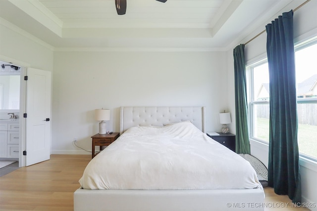 13657 S 21st Ct E, Bixby, OK 74008 - bedroom featuring a raised ceiling, multiple windows, and light wood finished floors