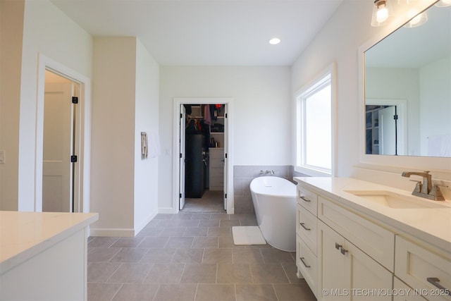 13657 S 21st Ct E, Bixby, OK 74008 - full bathroom featuring vanity, a freestanding tub, a spacious closet, and recessed lighting
