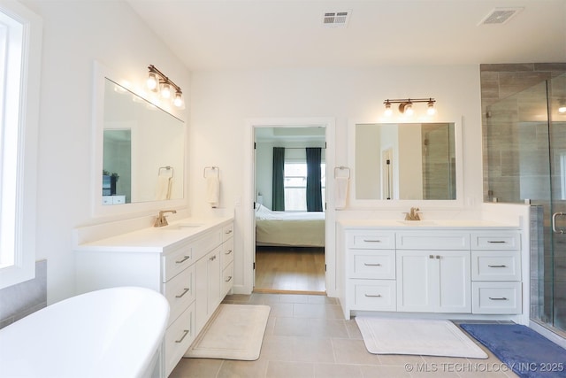13657 S 21st Ct E, Bixby, OK 74008 - bathroom with two vanities, a shower stall, tile patterned floors, and a freestanding bath