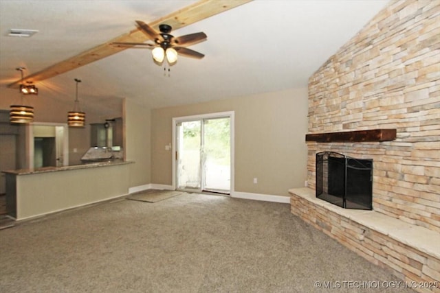 2005 Holly Rd, Claremore, OK 74017 - unfurnished living room featuring carpet floors, a stone fireplace, a ceiling fan, and baseboards