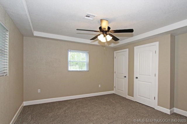 2005 Holly Rd, Claremore, OK 74017 - unfurnished bedroom with carpet floors, a tray ceiling, and baseboards