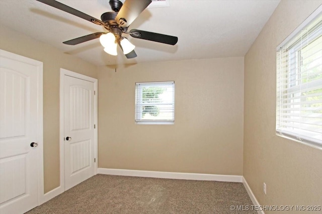 2005 Holly Rd, Claremore, OK 74017 - unfurnished bedroom with carpet, baseboards, and ceiling fan
