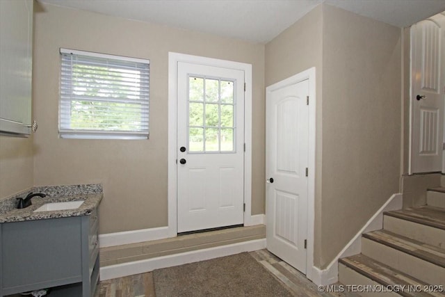 2005 Holly Rd, Claremore, OK 74017 - entryway featuring a sink, light wood-type flooring, baseboards, and stairs