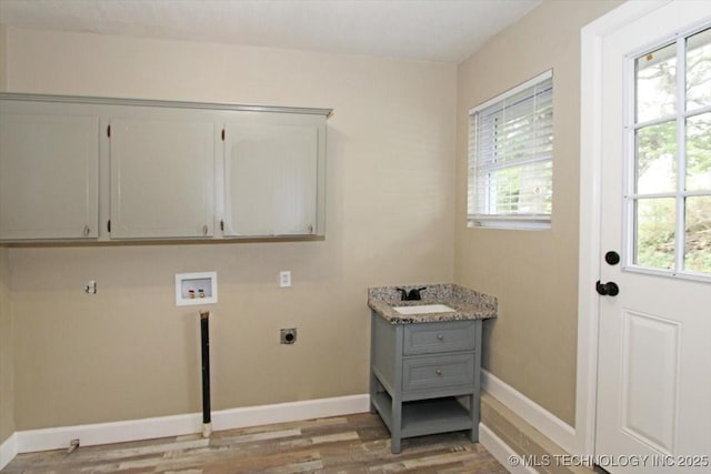 2005 Holly Rd, Claremore, OK 74017 - washroom featuring hookup for an electric dryer, hookup for a washing machine, cabinet space, and plenty of natural light