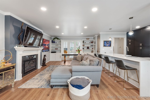 5206 S Harvard Ave Unit 308, Tulsa, OK 74135 - living area featuring crown molding, light wood-style flooring, a glass covered fireplace, recessed lighting, and baseboards