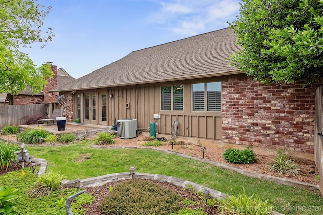 5206 S Harvard Ave Unit 308, Tulsa, OK 74135 - back of house featuring roof with shingles, central air condition unit, a patio area, and brick siding