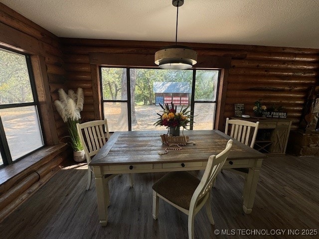 13248 Spelling Rd, Davis, OK 73030 - dining space with log walls, a textured ceiling, and wood finished floors
