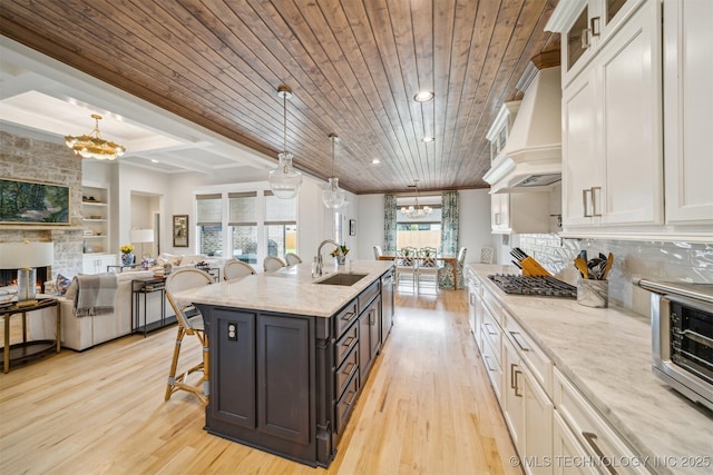 5918 E 127th Pl S, Tulsa, OK 74008 - kitchen with a chandelier, a breakfast bar, light wood finished floors, crown molding, and wood ceiling