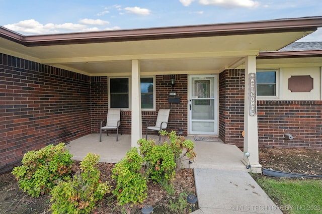 3823 S 88th E Pl, Tulsa, OK 74145 - view of exterior entry with a porch and brick siding