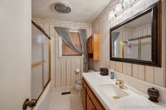 3823 S 88th E Pl, Tulsa, OK 74145 - bathroom with wallpapered walls, vanity, toilet, tile patterned flooring, and combined bath / shower with glass door