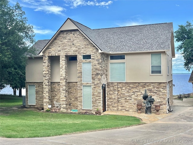 5168 Tower Dr, Kingston, OK 73439 - view of front facade featuring stucco siding, stone siding, a shingled roof, and a front lawn