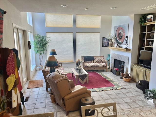 5168 Tower Dr, Kingston, OK 73439 - living area featuring plenty of natural light, a tiled fireplace, and light tile patterned flooring