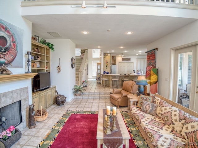 5168 Tower Dr, Kingston, OK 73439 - living room featuring stairs, a fireplace, light tile patterned flooring, and recessed lighting