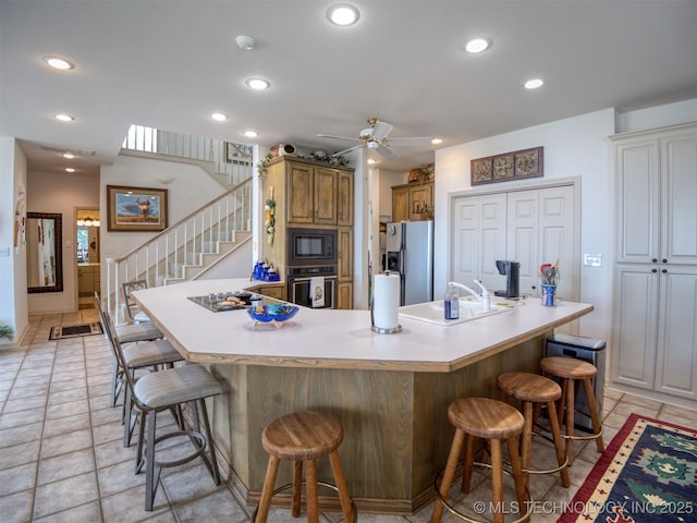 5168 Tower Dr, Kingston, OK 73439 - kitchen featuring black appliances, a kitchen breakfast bar, a sink, a ceiling fan, and recessed lighting
