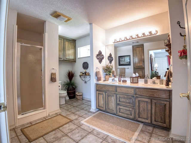 5168 Tower Dr, Kingston, OK 73439 - full bathroom featuring toilet, double vanity, a shower stall, baseboards, and a textured ceiling