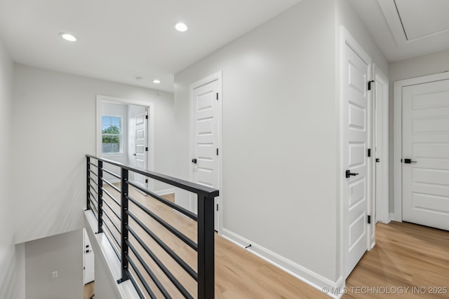 1448 N Main St Unit 2, Tulsa, OK 74106 - hall featuring light wood finished floors, recessed lighting, an upstairs landing, baseboards, and attic access