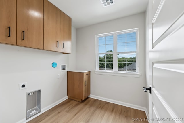 1448 N Main St Unit 2, Tulsa, OK 74106 - laundry area featuring electric dryer hookup, light wood finished floors, washer hookup, baseboards, and cabinet space