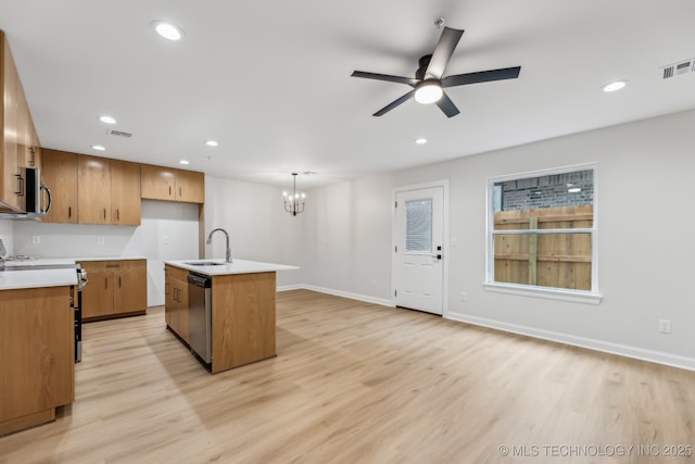 1448 N Main St Unit 2, Tulsa, OK 74106 - kitchen with stainless steel appliances, a sink, a chandelier, ceiling fan, and light wood-style floors