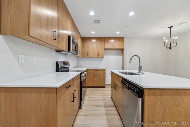 1448 N Main St Unit 2, Tulsa, OK 74106 - kitchen with appliances with stainless steel finishes, a sink, light wood-type flooring, light countertops, and a chandelier