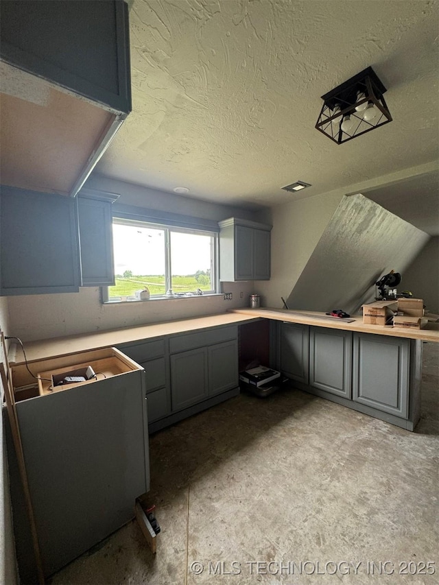 7235 Sunshine Rd, Davis, OK 73030 - kitchen with gray cabinetry, a textured ceiling, and light countertops