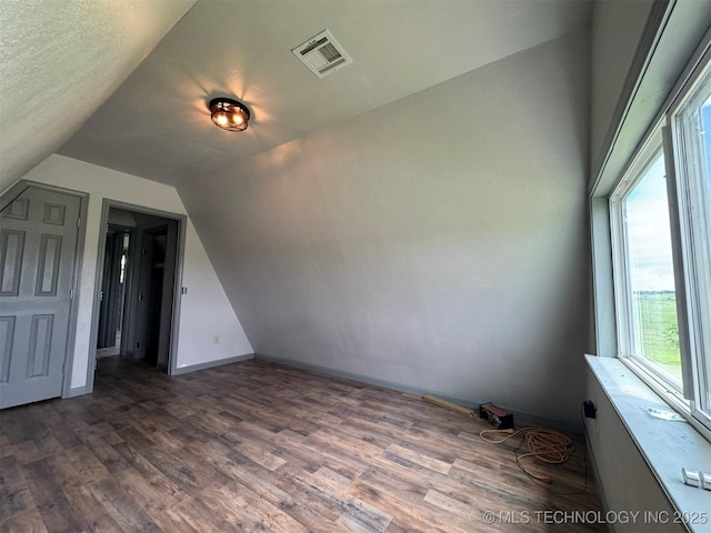 7235 Sunshine Rd, Davis, OK 73030 - bonus room featuring vaulted ceiling, wood finished floors, baseboards, and plenty of natural light